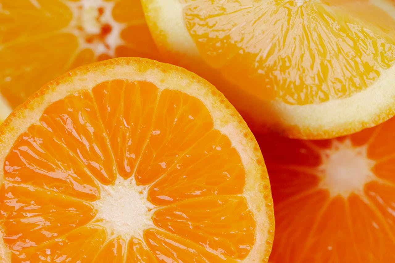 Vibrant close-up of sliced oranges showcasing their juicy texture and bright color.